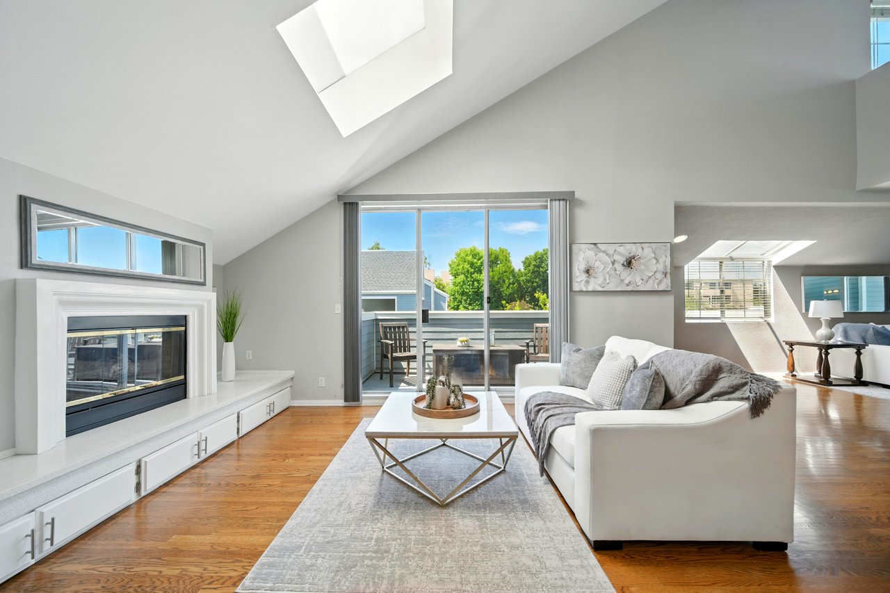 Living room with vaulted ceilings and skylights